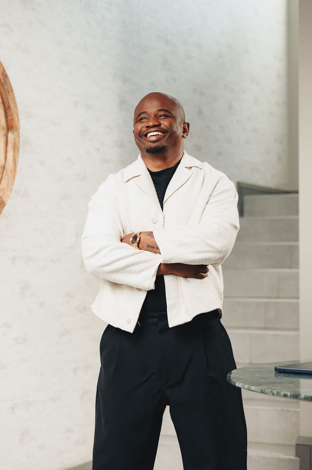 Dr Better laughing warmly, arms crossed