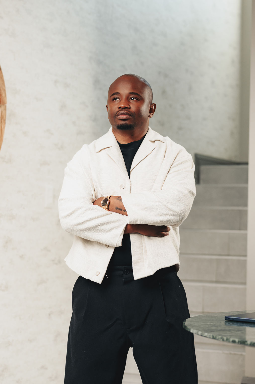 Dr Better standing confidently, arms crossed